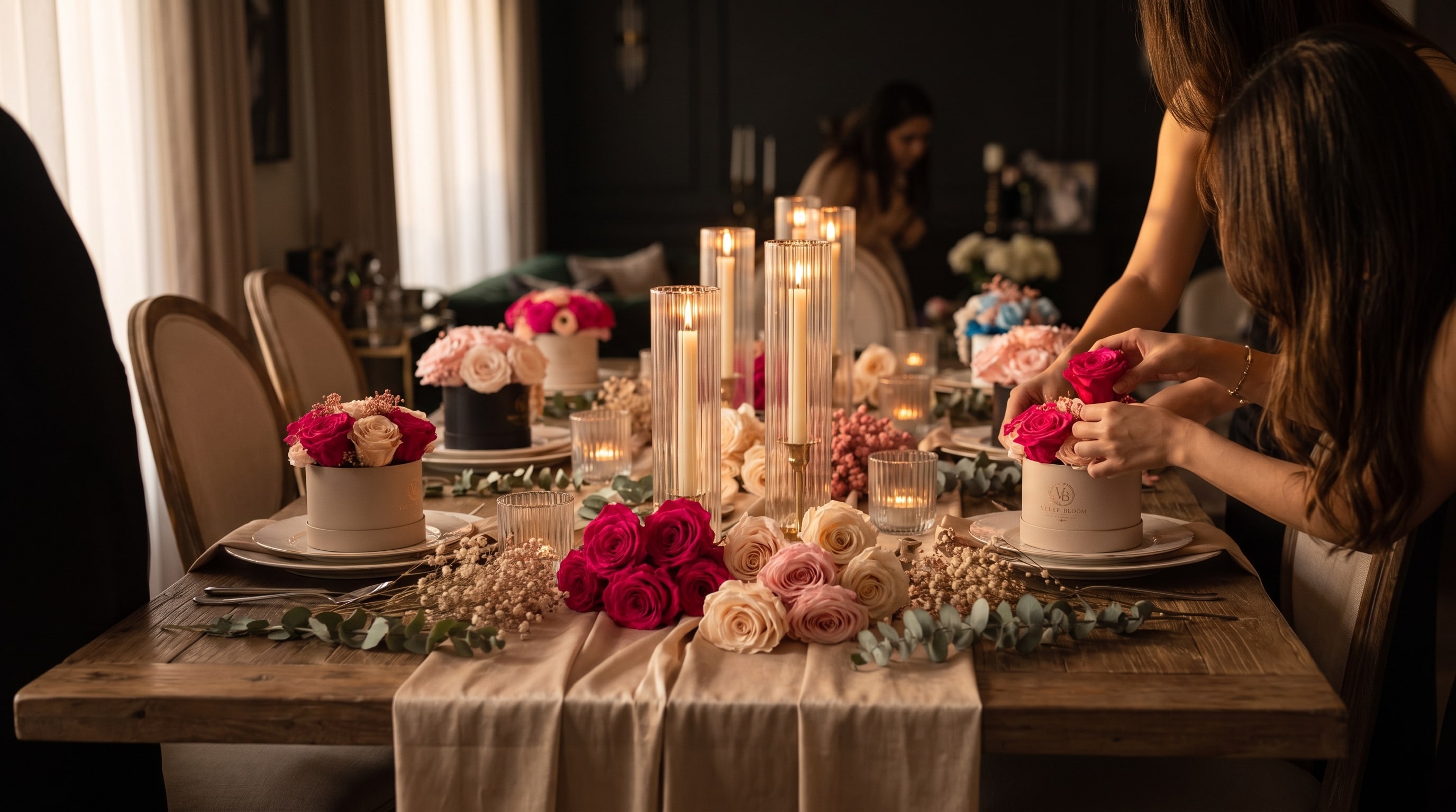 A long table set by candlelight for a private floral experience, guests arranging preserved roses