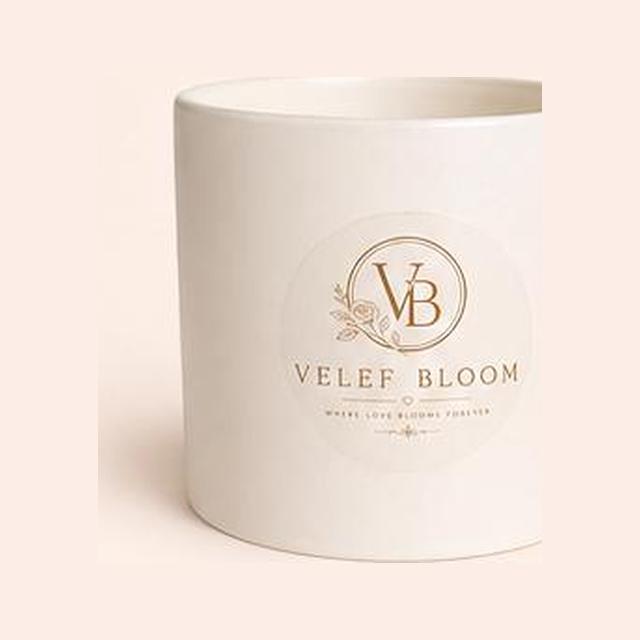Empty white Velef Bloom Signature ceramic vessel with the gold monogram